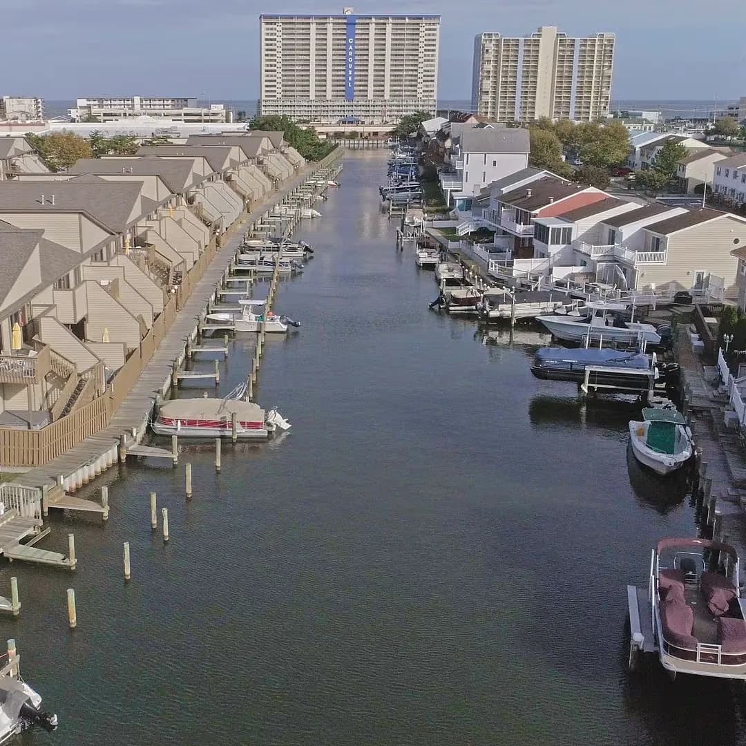Waterfront townhouses with private docks, boat access, and distant high-rise views.