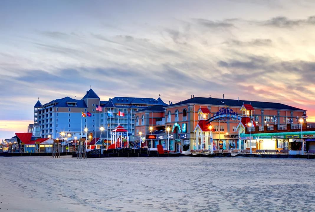 Ocean City fishing pier silhouetted against a colorful sunset.